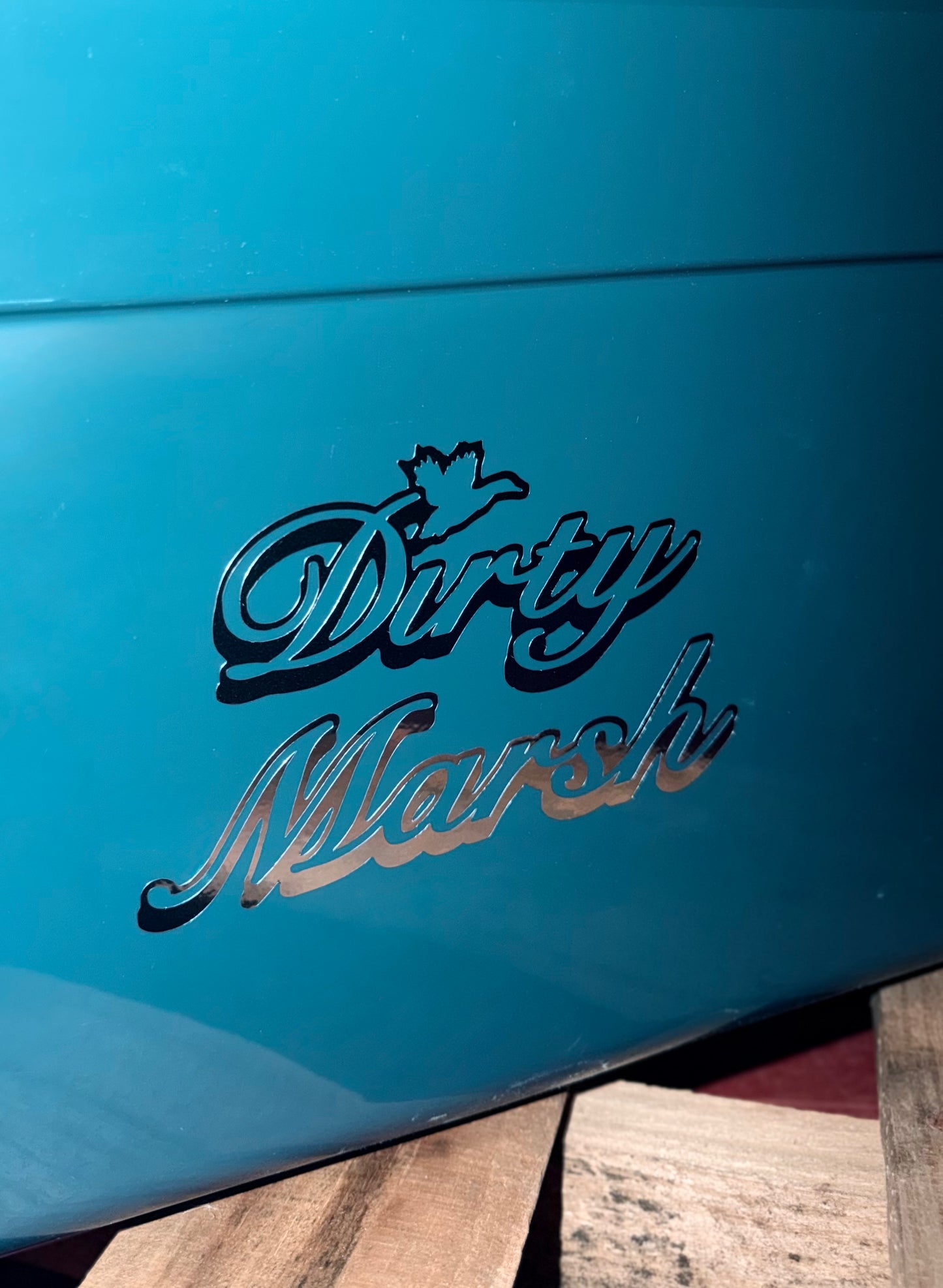Chrome 6" "Dirty Marsh" decal with a bird silhouette, applied to a teal surface.