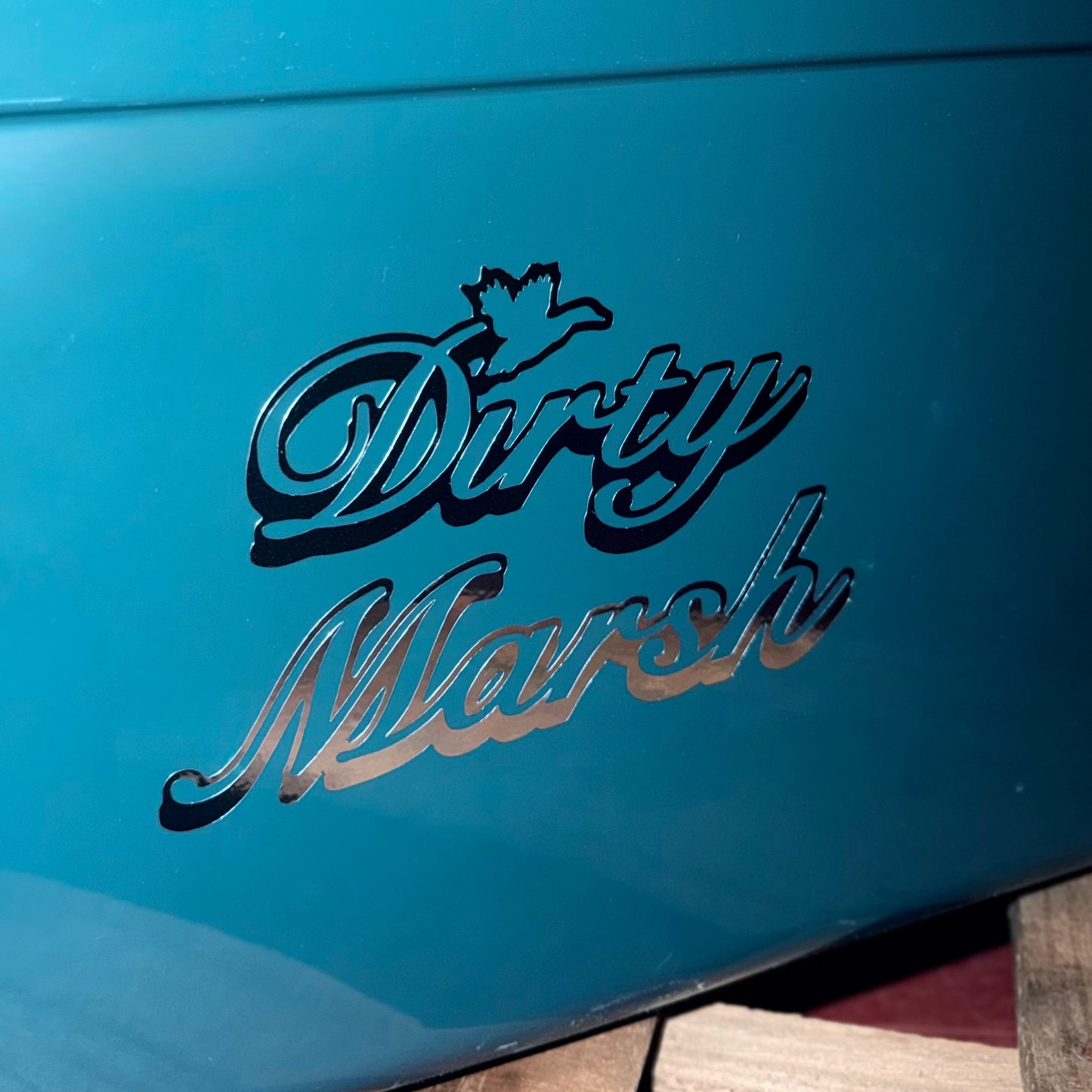 Chrome "Dirty Marsh" 6" decal with a duck silhouette, applied to a teal surface.
