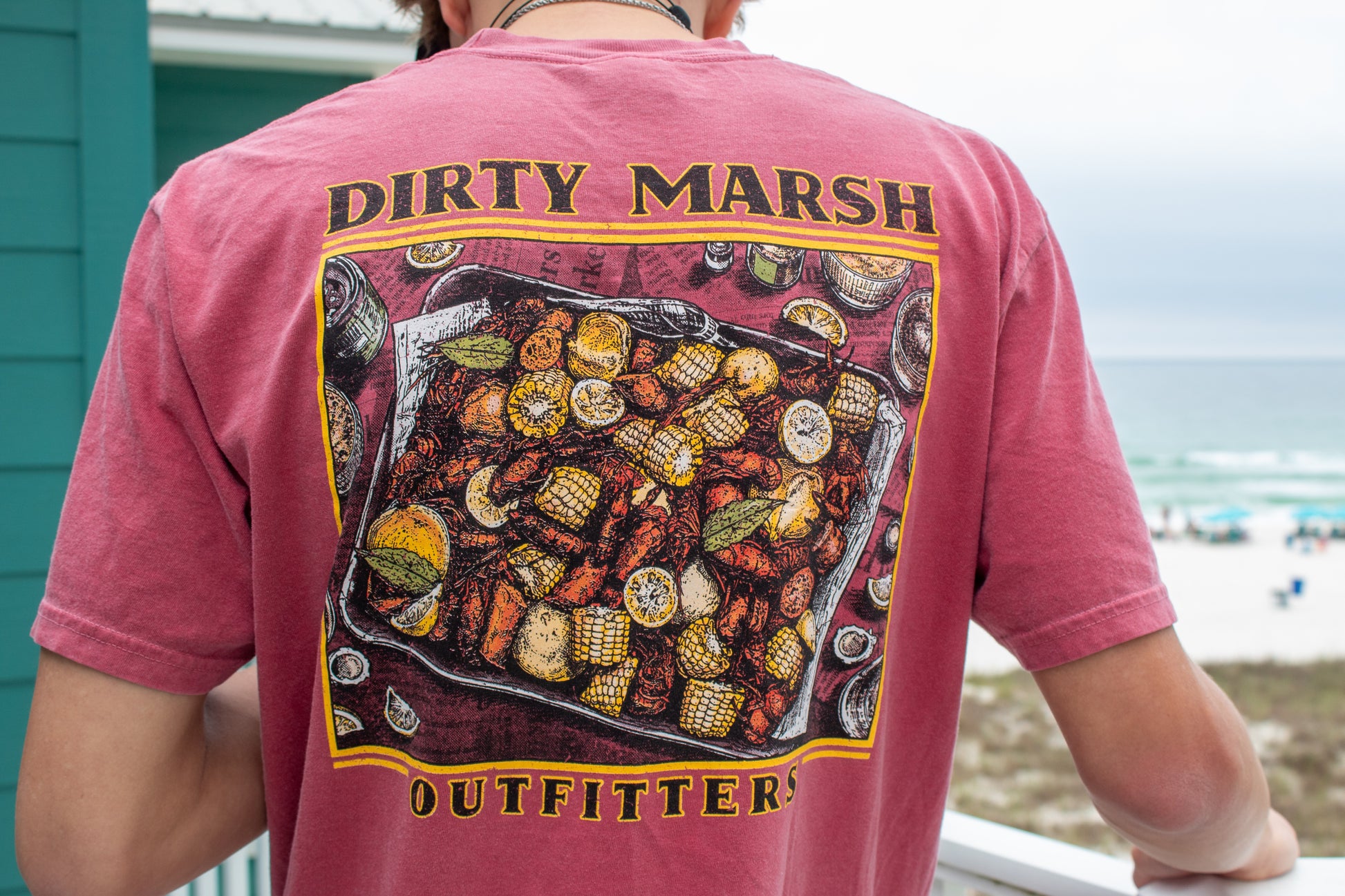 Red Dirty Marsh Outfitters Crawfish Boil tee with a detailed graphic of crawfish, corn, and lemons.